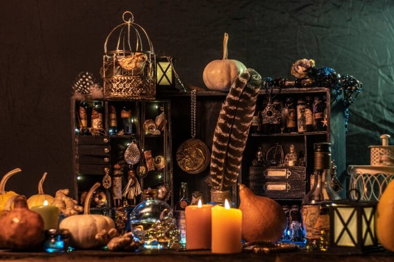 Witches altar with candles potions pumpkins and feathers