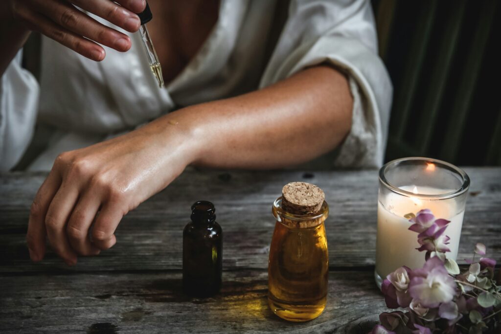a person applying a dropper on a hand