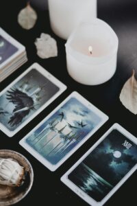 a group of tarot cards and a candle