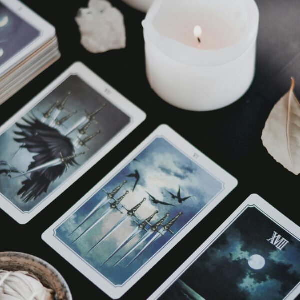 a group of tarot cards and a candle