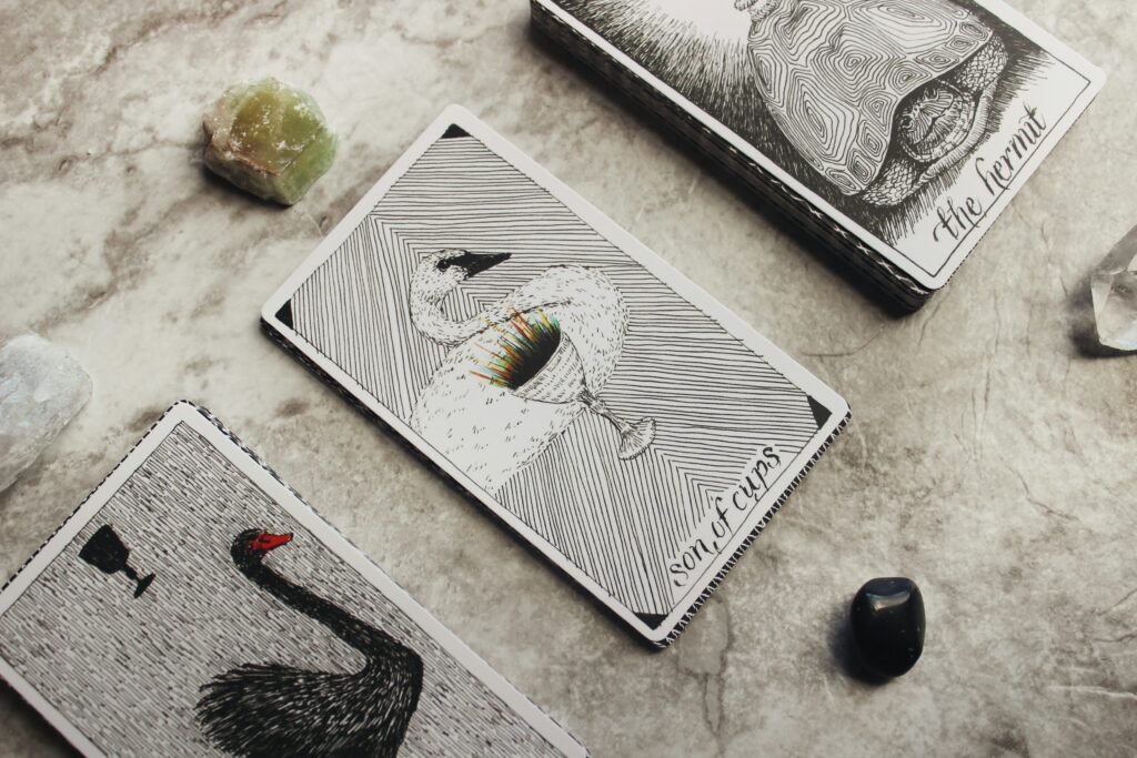 a deck of tarot cards and crystal