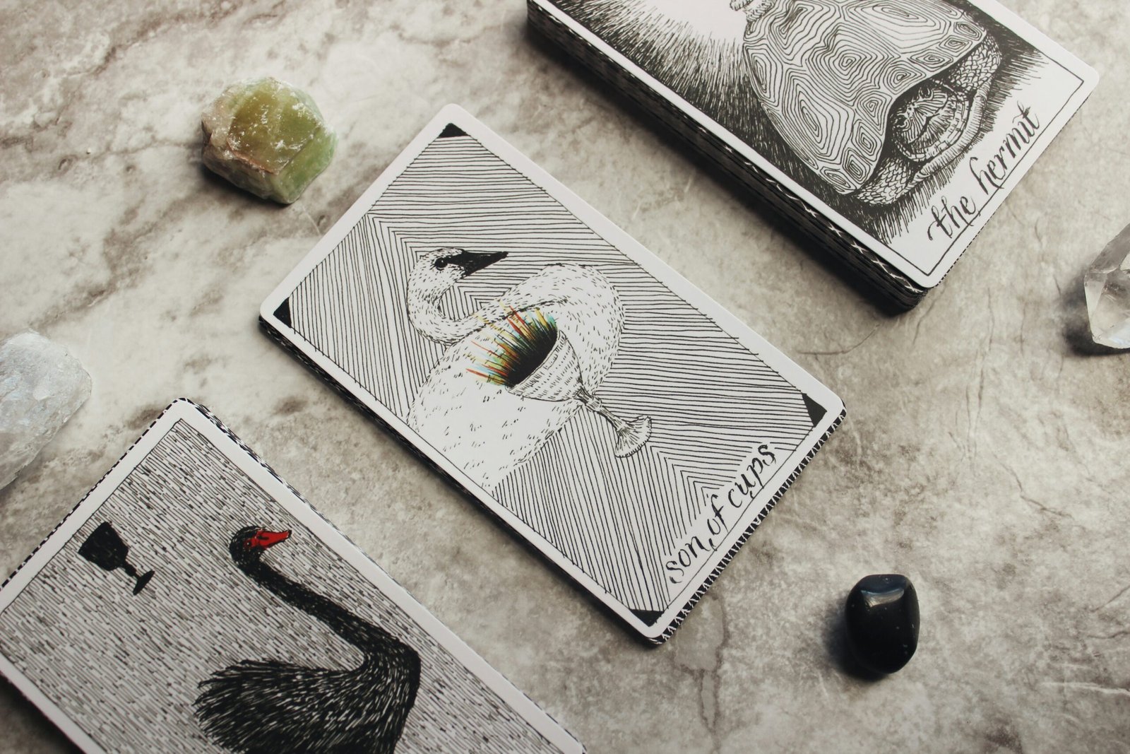 a deck of tarot cards and crystal