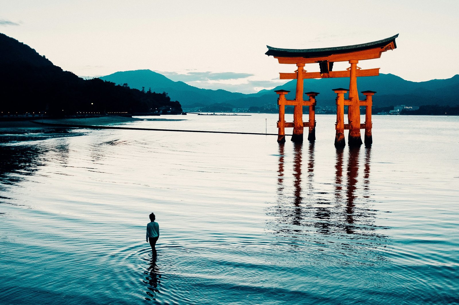 a person standing in water with a large wooden structure